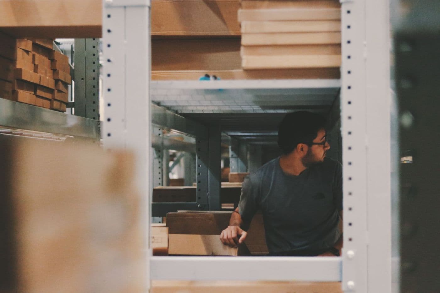 Warehouse shelving with cartons being picked.