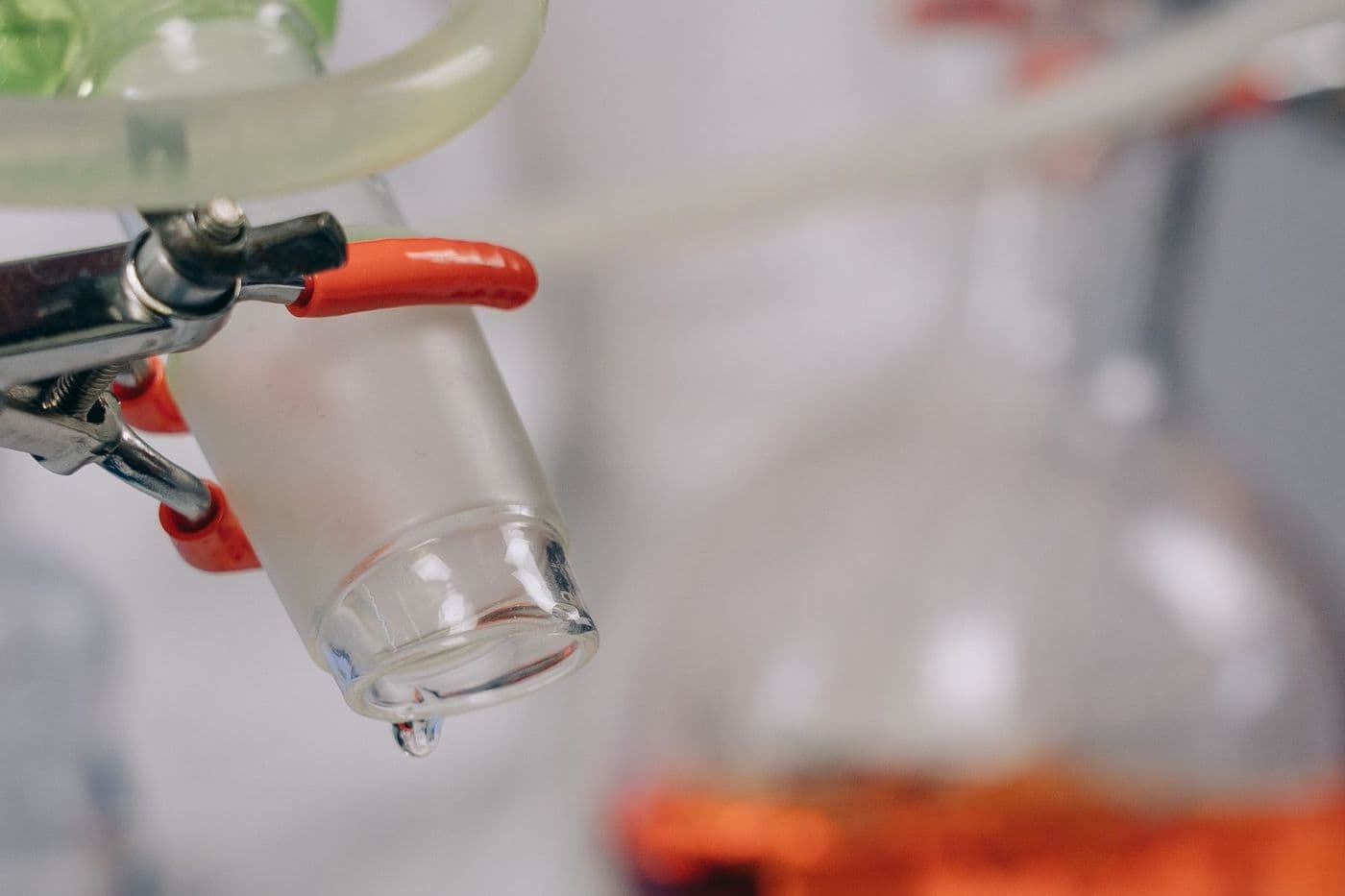 Laboratory glassware and clamps on a bench.